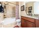 Bathroom with granite countertop, shower/tub combo, and patterned curtain at 25822 Feather Ridge Ln, Sorrento, FL 32776