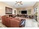 Relaxing Gathering room with a large sectional sofa and built-in shelving at 25822 Feather Ridge Ln, Sorrento, FL 32776