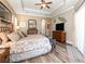 Bright and airy Primary bedroom with a king-size bed and ample closet space at 25822 Feather Ridge Ln, Sorrento, FL 32776