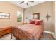 Bedroom with a metal bed frame and a wooden chest at 25822 Feather Ridge Ln, Sorrento, FL 32776