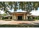 Elegant clubhouse entrance with brick pavers and landscaping at 25822 Feather Ridge Ln, Sorrento, FL 32776