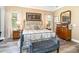 Spacious Primary bedroom with large bed, dresser, and plenty of natural light at 25822 Feather Ridge Ln, Sorrento, FL 32776
