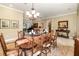 Formal dining room with wooden table, chandelier, and decorative runner at 25822 Feather Ridge Ln, Sorrento, FL 32776