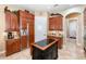 Kitchen boasts an island, stainless steel appliances, and rich wood cabinets at 25822 Feather Ridge Ln, Sorrento, FL 32776