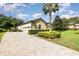 One-story home with paver driveway and lush landscaping at 25822 Feather Ridge Ln, Sorrento, FL 32776