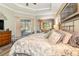 Primary bedroom with pool view, king-size bed, and access to the backyard at 25822 Feather Ridge Ln, Sorrento, FL 32776