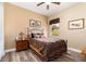 Cozy guest bedroom with a comfortable queen-size bed and wood furniture at 25822 Feather Ridge Ln, Sorrento, FL 32776