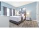 Comfortable bedroom with a gray upholstered bed and gray curtains at 740 Pebble Beach Dr, Davenport, FL 33896
