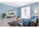 Cozy living room featuring a comfy couch, a large TV, and plenty of natural light at 740 Pebble Beach Dr, Davenport, FL 33896