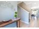 Light and airy entryway with light blue walls, wood console table, and view of dining room at 740 Pebble Beach Dr, Davenport, FL 33896