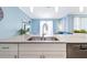 Modern kitchen with a large island, double sink, and stainless steel appliances at 740 Pebble Beach Dr, Davenport, FL 33896