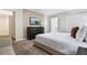 Spacious bedroom with TV, dresser, and large bed at 740 Pebble Beach Dr, Davenport, FL 33896
