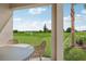 View from patio shows a lush green lawn and trees, offering a peaceful setting at 12965 Trovita Dr, Grand Island, FL 32735