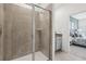 Walk-in shower with glass enclosure and gray tile at 12965 Trovita Dr, Grand Island, FL 32735
