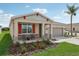 House exterior with a two-car garage and front porch at 12965 Trovita Dr, Grand Island, FL 32735