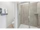 Shower stall with glass enclosure and gray tile at 12965 Trovita Dr, Grand Island, FL 32735