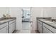 Double vanity bathroom with granite countertops and a view of the bedroom at 12965 Trovita Dr, Grand Island, FL 32735