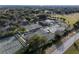 Aerial view of community tennis courts and clubhouse at 12965 Trovita Dr, Grand Island, FL 32735