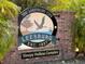 Welcome sign for Leesburg's Sleepy Hollow complex, featuring a lakeside scene and established date at 12965 Trovita Dr, Grand Island, FL 32735
