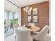 Casual dining area with wood table and accent wall at 12965 Trovita Dr, Grand Island, FL 32735