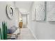 Bright hallway with light gray walls and a bench at 12965 Trovita Dr, Grand Island, FL 32735