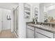 Bathroom with granite countertop, gray cabinets, and a walk-in shower at 12965 Trovita Dr, Grand Island, FL 32735