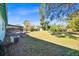 Backyard view showing a screened patio, garden beds and AC unit at 2811 Vine St, Orlando, FL 32806