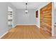 Light and airy dining room with hardwood floors and a rustic wood accent wall at 2811 Vine St, Orlando, FL 32806