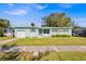 Charming light blue house with well-maintained lawn and driveway at 2811 Vine St, Orlando, FL 32806