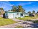 Light teal single story home with a well manicured lawn and driveway at 2811 Vine St, Orlando, FL 32806