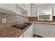 Modern kitchen with granite countertops and a sleek electric cooktop at 2811 Vine St, Orlando, FL 32806