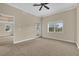 Well-lit bedroom with window, door to balcony, and ceiling fan at 7650 Whisper Way # 301, Reunion, FL 34747