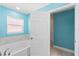 Bathroom with a bathtub, a window, and access to another room at 365 Cimarron Ct, Kissimmee, FL 34759