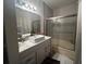 Clean bathroom with a tub, shower, and updated vanity at 3384 Corona Village Way # 108, Orlando, FL 32835