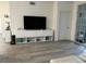 Living area featuring hardwood floors and a large TV at 3384 Corona Village Way # 108, Orlando, FL 32835
