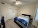 Bright bedroom with double bed, large closet, and wood-look flooring at 3384 Corona Village Way # 108, Orlando, FL 32835