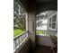 Relaxing screened balcony overlooking a scenic lake and lush green space at 3384 Corona Village Way # 108, Orlando, FL 32835