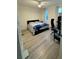Bedroom with a queen bed, home office setup and wood-look floors at 3384 Corona Village Way # 108, Orlando, FL 32835