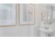 Small powder room with pedestal sink and round mirror at 2204 Tongass Bnd, Davenport, FL 33837