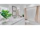 Clean bathroom with granite countertop, bathtub, and updated fixtures at 2204 Tongass Bnd, Davenport, FL 33837
