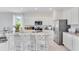 Modern kitchen with island, granite countertops and white cabinets at 2204 Tongass Bnd, Davenport, FL 33837
