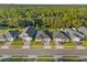 Aerial view of a row of houses with gray roofs and green lawns at 212 Golden Sands Cir, Davenport, FL 33837