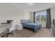 Comfortable bedroom with large window, carpeted floors, and workspace at 212 Golden Sands Cir, Davenport, FL 33837