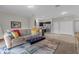 Open living room with view of kitchen and access to hallway at 212 Golden Sands Cir, Davenport, FL 33837