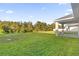 Large grassy backyard with a covered patio at 212 Golden Sands Cir, Davenport, FL 33837