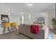 Living area features a cozy sofa, large TV, and kitchen views at 212 Golden Sands Cir, Davenport, FL 33837