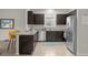 Modern kitchen with dark cabinetry, granite countertops, and stainless steel appliances at 212 Golden Sands Cir, Davenport, FL 33837