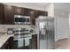 Modern kitchen with stainless steel appliances and granite countertops at 212 Golden Sands Cir, Davenport, FL 33837