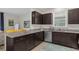 Modern kitchen with dark cabinetry, granite countertops and stainless steel appliances at 212 Golden Sands Cir, Davenport, FL 33837