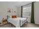 Bright bedroom with a comfortable bed and window with green curtains at 212 Golden Sands Cir, Davenport, FL 33837